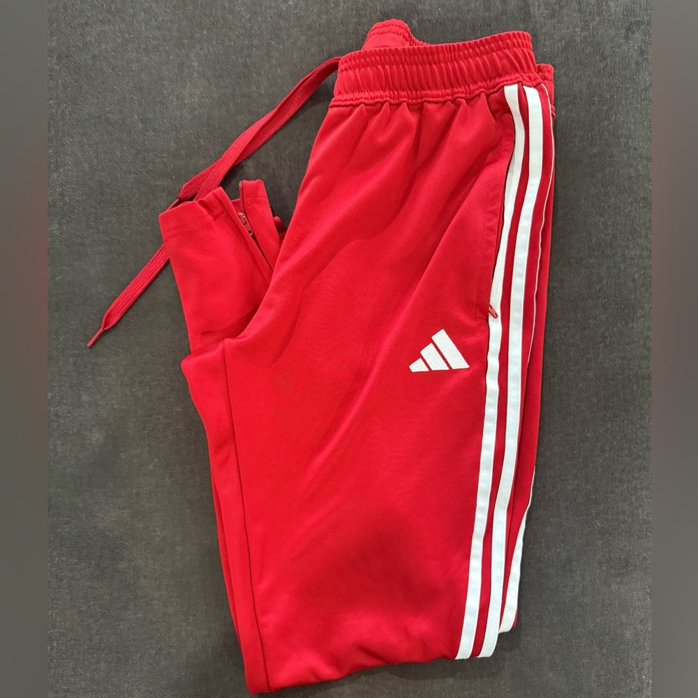Adidas men’s Red Joggers with 3 Stripes signature design. Zipper pockets Size M